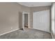 Carpeted bedroom with closet and view to hall at 9871 Nonacrest Dr, Orlando, FL 32832