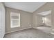 Open carpeted bedroom with vaulted ceiling and large window at 9871 Nonacrest Dr, Orlando, FL 32832