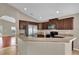 Modern kitchen featuring stainless steel appliances and a breakfast bar overlooking the dining area at 9871 Nonacrest Dr, Orlando, FL 32832