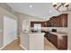 Open kitchen featuring stainless steel appliances and a breakfast bar overlooking the dining area at 9871 Nonacrest Dr, Orlando, FL 32832