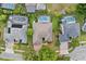 An aerial view of a home with a shingled roof, landscaped yard, and a screened-in pool at 10030 Chatham Oaks Ct, Orlando, FL 32836