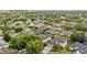 The residential neighborhood has mature trees, manicured lawns, screened pools, and a lake at 10030 Chatham Oaks Ct, Orlando, FL 32836
