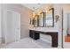 Bathroom featuring a sink, three mirrors and a separate door to a toilet and shower area at 10030 Chatham Oaks Ct, Orlando, FL 32836