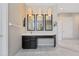 Bright bathroom featuring a dark vanity with white countertops, tile floors, and modern lighting at 10030 Chatham Oaks Ct, Orlando, FL 32836