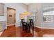 Cozy dining area with stylish lighting fixture, hardwood floors and ample natural light at 10030 Chatham Oaks Ct, Orlando, FL 32836