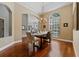 Formal dining room featuring hardwood floors, modern chandelier, and arched doorway at 10030 Chatham Oaks Ct, Orlando, FL 32836