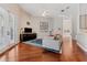 Open living room features a ceiling fan, wood floors, a sliding glass door, and neutral wall paint at 10030 Chatham Oaks Ct, Orlando, FL 32836