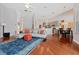 Bright living room featuring hardwood floors, an open layout, and views of the kitchen and dining area at 10030 Chatham Oaks Ct, Orlando, FL 32836