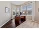 Home office featuring hardwood floors, a large window, and a door to the outside at 10030 Chatham Oaks Ct, Orlando, FL 32836