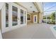 Covered patio with french doors and plenty of space for seating with pool views at 10030 Chatham Oaks Ct, Orlando, FL 32836