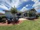 Outdoor patio with a grill, table, and chair seating, and sunroom at 10075 Sw 91St Pl, Ocala, FL 34481