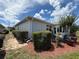 Backyard area with hedges, mature landscaping, and hardscape patio at 10075 Sw 91St Pl, Ocala, FL 34481