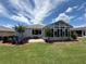 Backyard patio with a grill and a sunroom, perfect for entertaining at 10075 Sw 91St Pl, Ocala, FL 34481