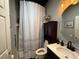 View of the bathroom featuring a vanity with a round mirror and shower with patterned curtain at 10075 Sw 91St Pl, Ocala, FL 34481