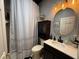 View of the bathroom featuring a vanity with a round mirror and shower with patterned curtain at 10075 Sw 91St Pl, Ocala, FL 34481