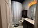 Stylish bathroom with a vanity, toilet, and decorative shower curtain, complete with modern lighting at 10075 Sw 91St Pl, Ocala, FL 34481