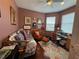 Inviting bedroom featuring hardwood floors, a daybed, and a cozy workspace near a bright window at 10075 Sw 91St Pl, Ocala, FL 34481