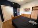 Bedroom with dark accent wall, wood bed set, and spacious closet at 10075 Sw 91St Pl, Ocala, FL 34481