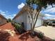 Side view of a one story home with a two car garage and mature landscaping at 10075 Sw 91St Pl, Ocala, FL 34481