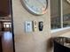 View of thermostat and fan remotes on the wall, window and part of the sunroom at 10075 Sw 91St Pl, Ocala, FL 34481