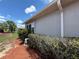 Close-up of the side of a home showing the exterior wall and landscaping at 10075 Sw 91St Pl, Ocala, FL 34481