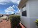 Exterior corner of the house with a garden and window at 10075 Sw 91St Pl, Ocala, FL 34481
