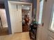Inviting foyer with a view of a cozy living room featuring hardwood floors and stylish decor at 10075 Sw 91St Pl, Ocala, FL 34481