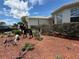 Well-maintained front yard with a decorative metal sculpture and mature landscaping under a bright blue sky at 10075 Sw 91St Pl, Ocala, FL 34481