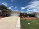 Charming single-story home featuring a well-maintained front yard and a two-car garage at 10075 Sw 91St Pl, Ocala, FL 34481
