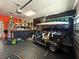 Well-equipped garage with golf cart, storage cabinets, and workshop area at 10075 Sw 91St Pl, Ocala, FL 34481