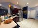 Open kitchen layout includes stainless steel refrigerator and stylish tile flooring at 10075 Sw 91St Pl, Ocala, FL 34481