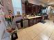 Spacious kitchen with stainless steel appliances, wine cooler, and tile flooring at 10075 Sw 91St Pl, Ocala, FL 34481