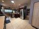 Open kitchen and dining area layout with stainless steel appliances and tile flooring at 10075 Sw 91St Pl, Ocala, FL 34481