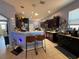 Kitchen with stainless appliances, updated cabinets, two bar stools, and pendant lighting at 10075 Sw 91St Pl, Ocala, FL 34481