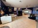 Open-concept living room with tile flooring and multiple seating areas at 10075 Sw 91St Pl, Ocala, FL 34481