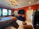 Comfortable main bedroom with tiled floor, ceiling fan, and abundant natural light from large windows at 10075 Sw 91St Pl, Ocala, FL 34481