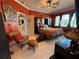 Comfortable main bedroom with tiled floor, ceiling fan, and abundant natural light from large windows at 10075 Sw 91St Pl, Ocala, FL 34481