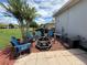 Cozy outdoor patio with chairs around a fire pit on the red mulch at 10075 Sw 91St Pl, Ocala, FL 34481