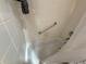 The shower features white tiles and a silver grab bar at 10075 Sw 91St Pl, Ocala, FL 34481