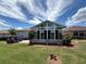 Sunroom with backyard views, lush landscaping, and stone accents at 10075 Sw 91St Pl, Ocala, FL 34481