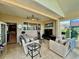 A bright sunroom with lots of natural light, ceiling fans, and plenty of seating at 10075 Sw 91St Pl, Ocala, FL 34481