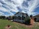 Enclosed sunroom with large windows and a landscaped backyard at 10075 Sw 91St Pl, Ocala, FL 34481