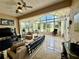 Bright sunroom with tile flooring, large windows, and comfortable seating for relaxing or entertaining at 10075 Sw 91St Pl, Ocala, FL 34481