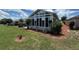 Enclosed sunroom featuring floor-to-ceiling windows and backyard views at 10075 Sw 91St Pl, Ocala, FL 34481