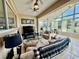This sunroom has great natural light, tile floor, ceiling fans, and comfortable seating at 10075 Sw 91St Pl, Ocala, FL 34481