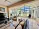 Bright sunroom featuring tile floors, lots of windows for great natural light, and comfortable seating at 10075 Sw 91St Pl, Ocala, FL 34481