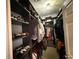 Organized walk-in closet with custom shelving, hanging rods, and ample storage for clothes and accessories at 10075 Sw 91St Pl, Ocala, FL 34481