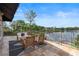 Outdoor patio with scenic lake view, stylish furniture, and wrought iron railing at 1010 Terrace Blvd, Orlando, FL 32803