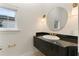 Modern bathroom featuring granite countertop, elegant mirror, and sconce lighting at 1010 Terrace Blvd, Orlando, FL 32803
