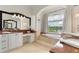 Luxurious bathroom showcasing a double vanity, soaking tub with a picturesque lake view at 1010 Terrace Blvd, Orlando, FL 32803